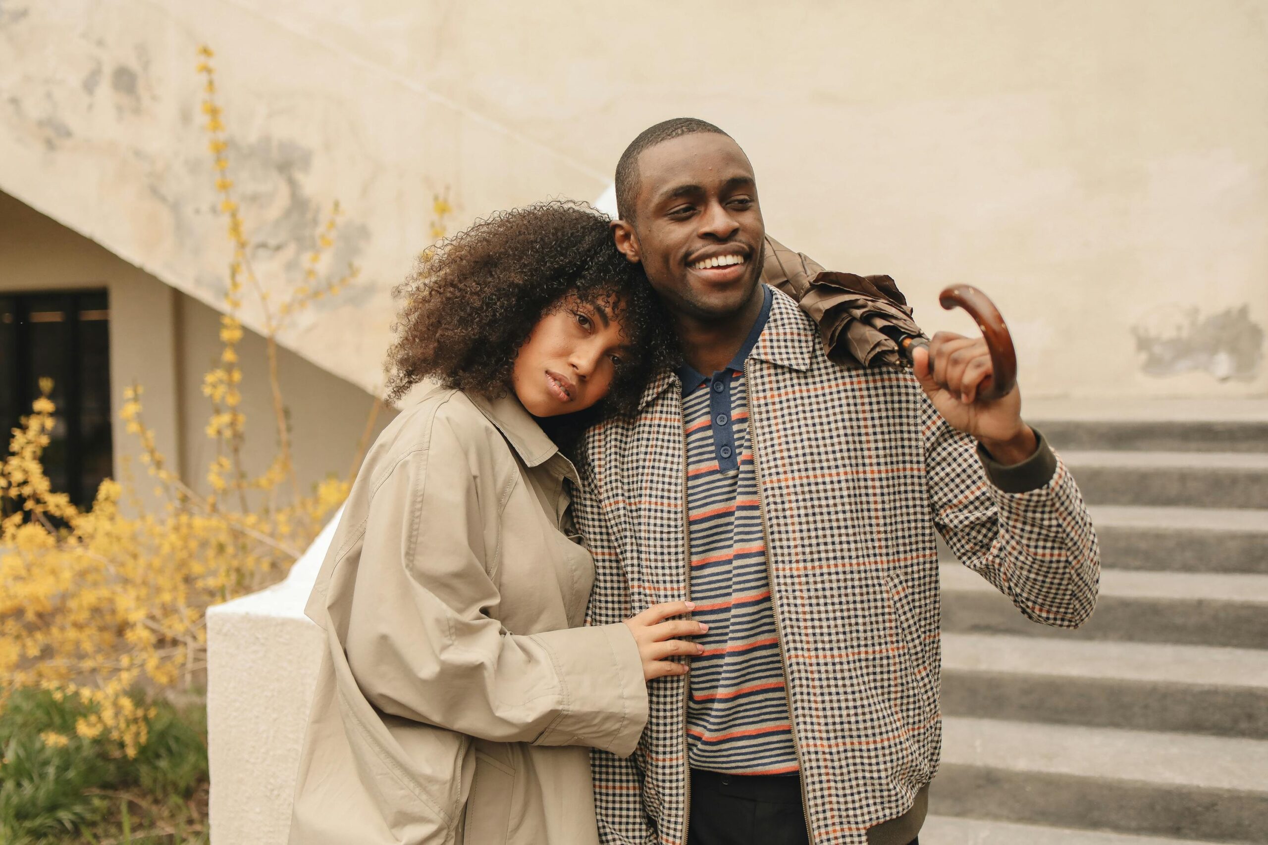 Happy couple enjoying togetherness outdoors on a bright day, sharing smiles and love.